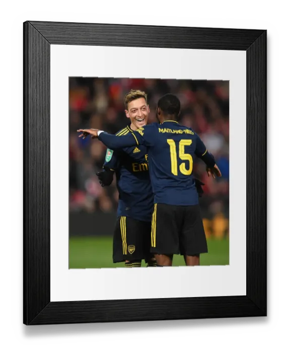 Framed Print : Arsenal's Four-Goal Blitz: Ozil and Maitland-Niles Jubilant Moment at Anfield