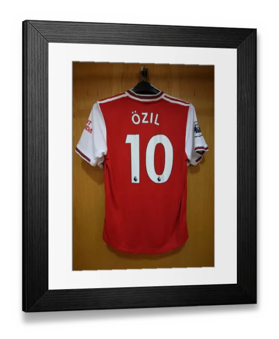Framed Print : Mesut Ozil's Absence: An Empty Arsenal Jersey in the Home Changing Room vs. Wolverhampton Wanderers (2019-20)