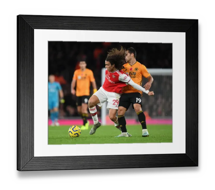 Framed Print : Arsenal's Guendouzi Outmaneuvers Wolves Jonny in Premier League Clash Framed Print : Arsenal's Guendouzi Outmaneuvers Wolves Jonny in Premier League Clash