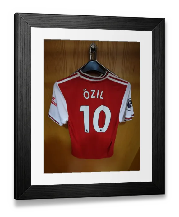 Framed Print : Mesut Ozil's Absence: Empty Hanger in Arsenal Changing Room vs. Wolverhampton Wanderers (2019-20)