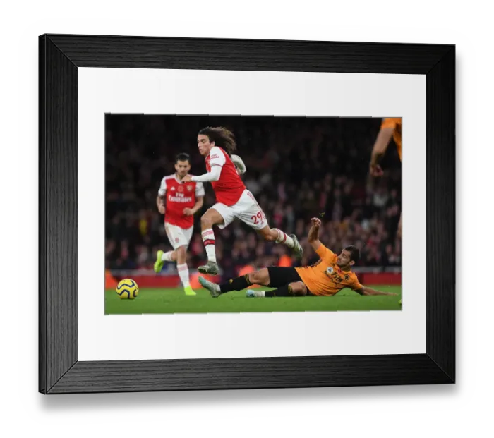 Framed Print : Guendouzi Soars: Arsenal's Matteo Jumps Over Cutrone in Premier League Clash vs. Wolverhampton