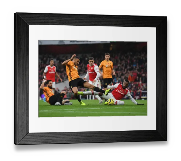 Framed Print : Lacazette vs. Saiss: A Premier League Showdown at Emirates Stadium