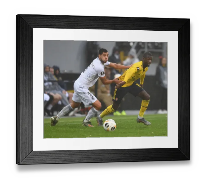 Framed Print : Pepe Clashes with Tapsoba: Vitoria Guimaraes vs. Arsenal, UEFA Europa League, Group F