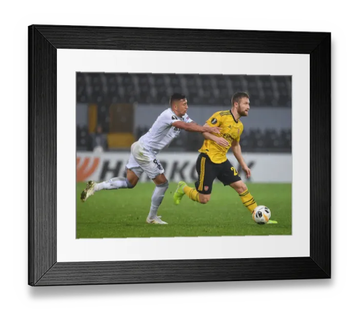 Framed Print : Mustafi's Powerful Run: Arsenal Overpowers Vitoria's Defense in Europa League Victory