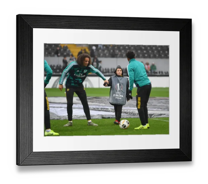 Framed Print : Arsenal Players Engage with Ballboy Before Vitoria Guimaraes Clash in Europa League