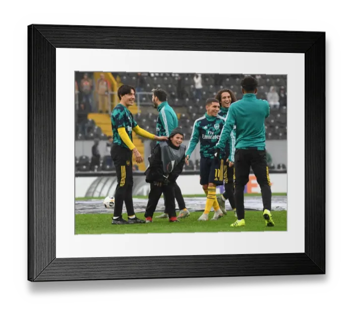 Framed Print : Arsenal Players Include Local Ballboy in Heartwarming Warm-Up Ahead of Vitoria Guimaraes Clash