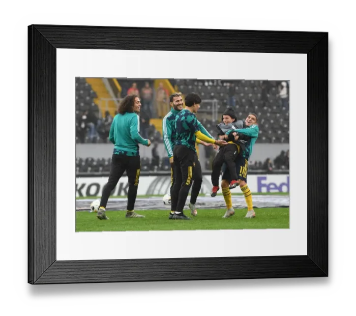 Framed Print : Arsenal Players Warm Up Ahead of Europa League Clash against Vitoria Guimaraes
