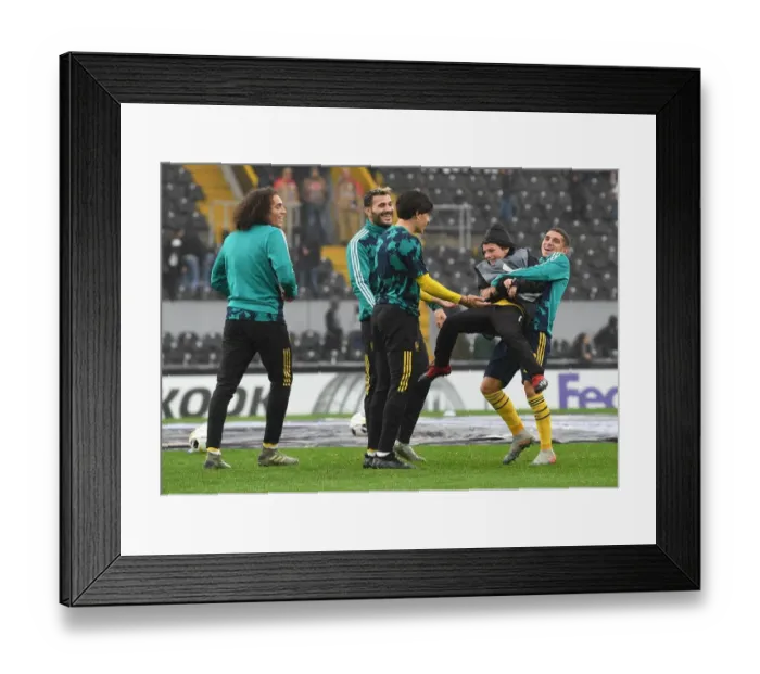 Framed Print : Arsenal Players Involve Local Ballboy in Unique Warm-Up Routine vs. Vitoria SC
