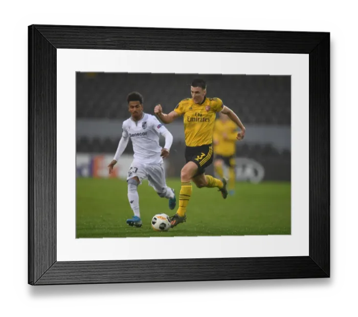 Framed Print : Arsenal's Kieran Tierney Goes Head-to-Head with Marcus Edwards in Europa League Showdown Framed Print : Arsenal's Kieran Tierney Goes Head-to-Head with Marcus Edwards in Europa League Showdown