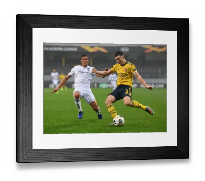 Framed Print : Arsenal's Kieran Tierney Clashes with Vitoria Guimaraes in Europa League Showdown