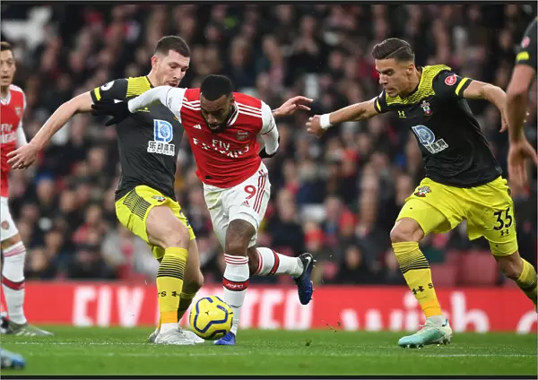 Arsenal's Lacazette Clashes with Southampton's Hojbjerg and Bednarek during the 2019-20 Premier League Match
