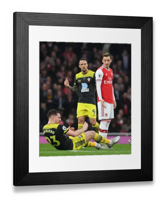 Framed Print : Arsenal vs Southampton: Ozil Stands Off Against Hojbjerg in Premier League Clash