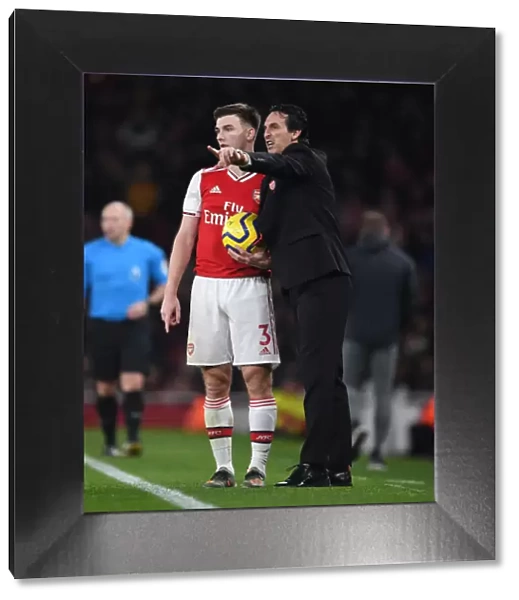 Strategic Discussions: Unai Emery and Kieran Tierney at Arsenal's Emirates Stadium