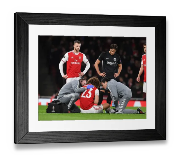 Framed Print : Arsenal's David Luiz Receives Medical Attention During Arsenal FC vs Eintracht Frankfurt UEFA Europa League Match Framed Print : Arsenal's David Luiz Receives Medical Attention During Arsenal FC vs Eintracht Frankfurt UEFA Europa League Match