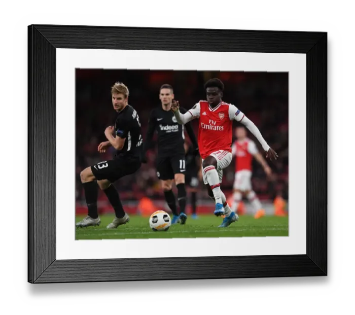 Framed Print : Arsenal's Bukayo Saka Goes Head-to-Head with Eintracht Frankfurt's Martin Hinteregger in Europa League Showdown
