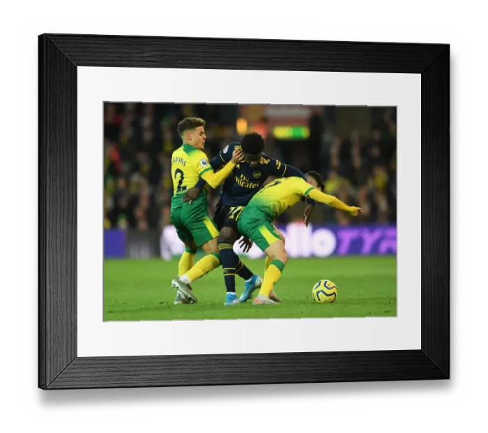 Framed Print : Bukayo Saka Faces Off Against Norwich Duo Amidst Premier League Action