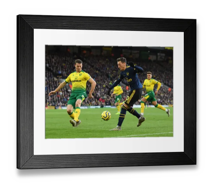 Framed Print : Mesut Ozil Evades Pressure from Christoph Zimmermann during Norwich City vs Arsenal Premier League Clash