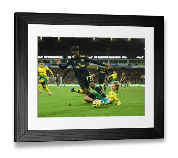 Framed Print : Bukayo Saka vs. Todd Cantwell: Battle at Carrow Road - Norwich City vs. Arsenal FC, Premier League 2019-20