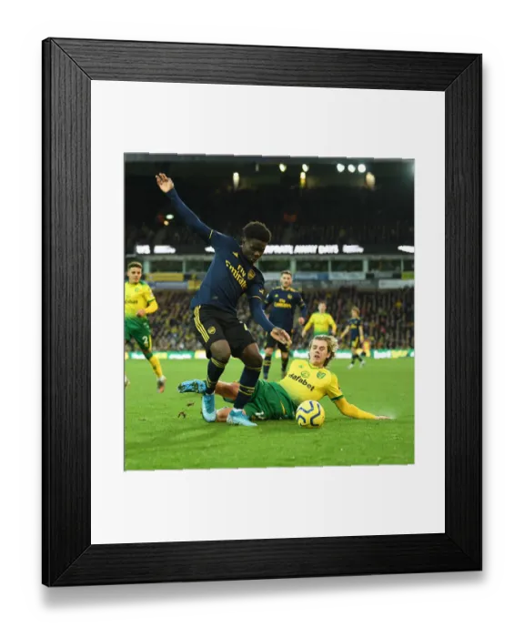 Framed Print : Saka vs. Cantwell: A Premier League Battle at Carrow Road