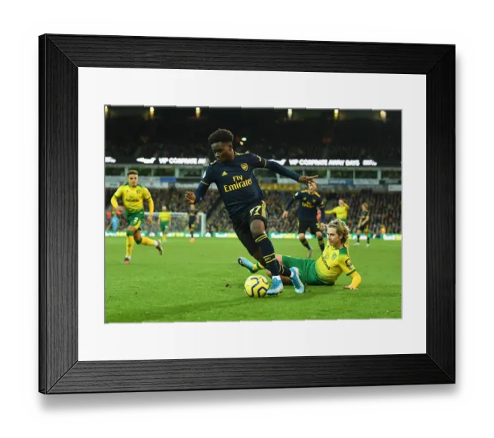 Framed Print : Bukayo Saka vs Todd Cantwell: Intense Battle at Carrow Road - Norwich City vs Arsenal FC, Premier League 2019-20