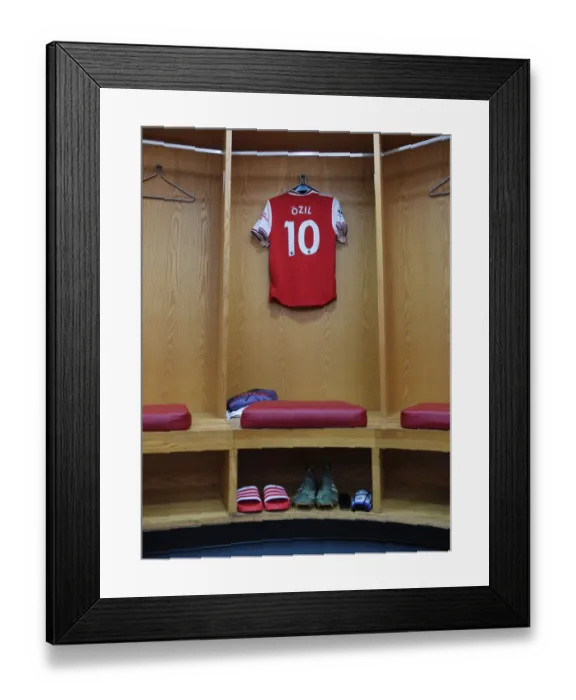 Framed Print : Mesut Ozil's Focus: Arsenal FC's Star Player Prepares for Battle against Brighton & Hove Albion (Premier League 2019-20)