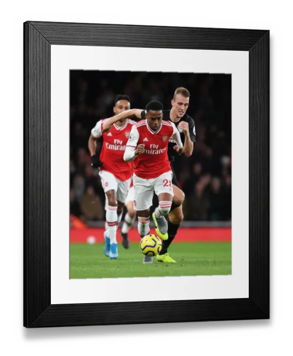 Framed Print : Arsenal's Joe Willock Outsmarts Dan Burn: A Premier League Battle at Emirates Stadium Framed Print : Arsenal's Joe Willock Outsmarts Dan Burn: A Premier League Battle at Emirates Stadium