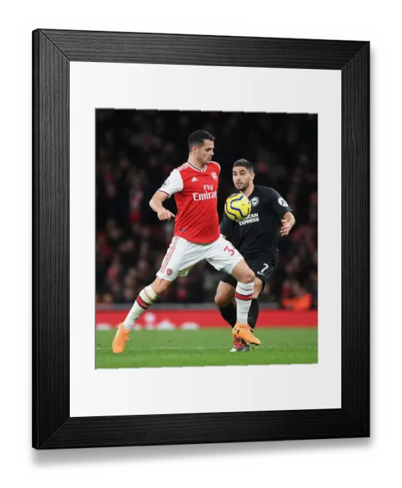 Framed Print : Clash of the Midfield Titans: Xhaka vs Maupay in Arsenal vs Brighton Premier League Battle