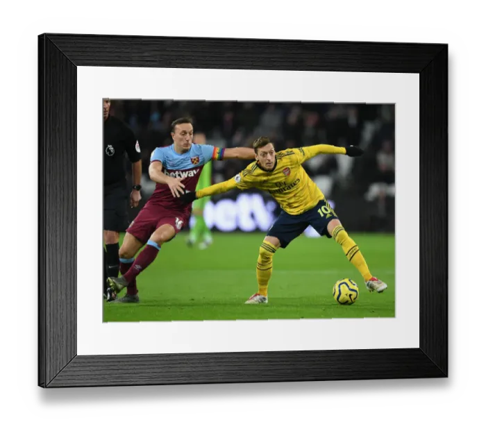 Framed Print : Mesut Ozil Holds Off Mark Noble: West Ham United vs Arsenal FC, Premier League 2019-20