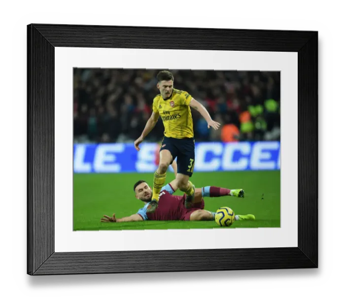 Framed Print : Arsenal's Kieran Tierney Outmaneuvers West Ham's Richard Snodgrass in Premier League Clash Framed Print : Arsenal's Kieran Tierney Outmaneuvers West Ham's Richard Snodgrass in Premier League Clash