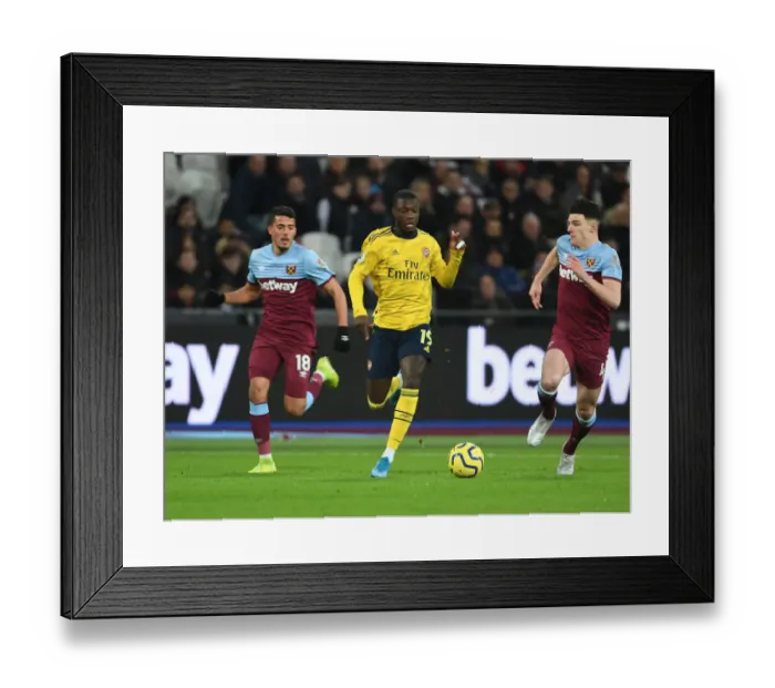 Framed Print : Nicolas Pepe Breaks Past West Ham's Fornals and Rice in Arsenal's Premier League Clash Framed Print : Nicolas Pepe Breaks Past West Ham's Fornals and Rice in Arsenal's Premier League Clash