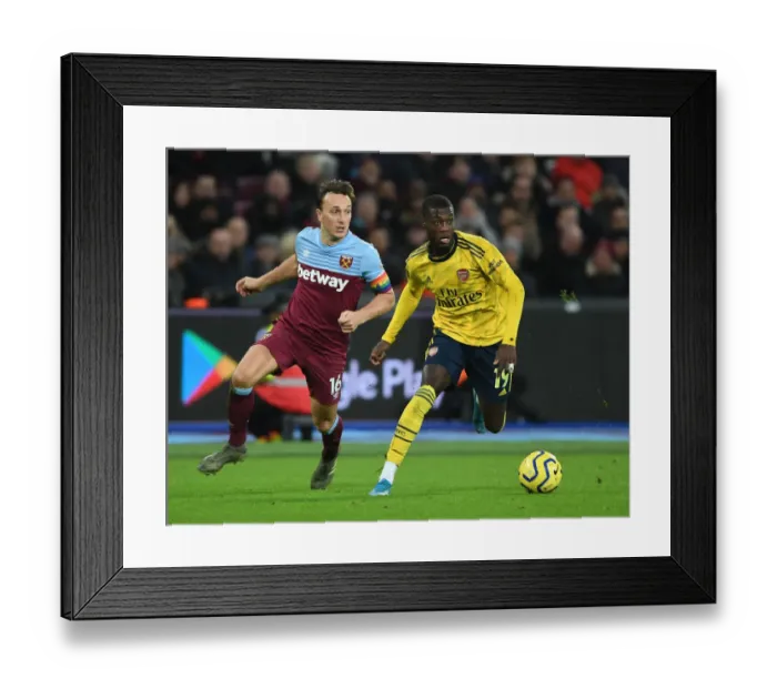 Framed Print : Nicolas Pepe Breaks Past Noble: West Ham vs Arsenal, Premier League 2019-20