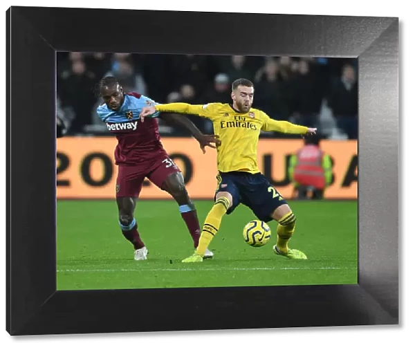 Arsenal's Calum Chambers Fends Off West Ham's Michail Antonio in Premier League Clash