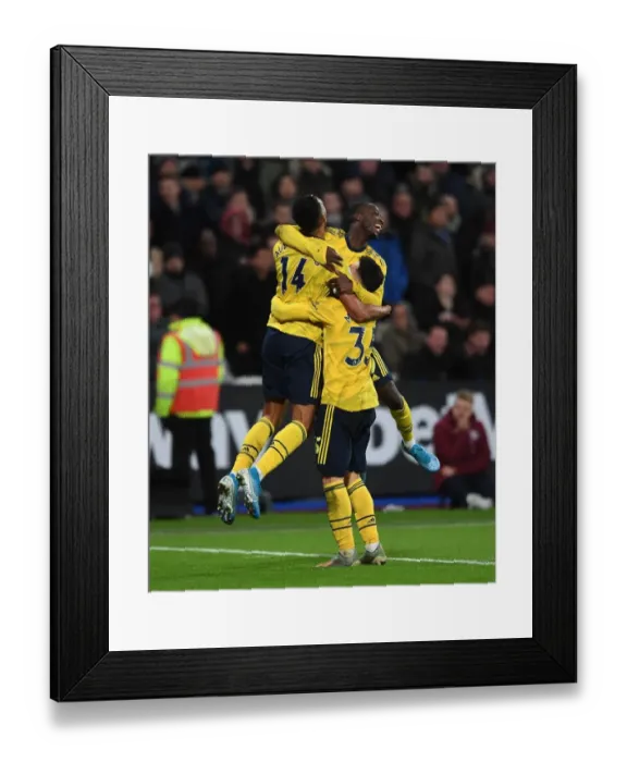 Framed Print : Pepe, Aubameyang, and Martinelli Celebrate Arsenal's Winning Goals Against West Ham United (December 2019)