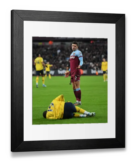 Framed Print : West Ham vs Arsenal: Cresswell Overlooks Injured Pepe in Intense Premier League Clash Framed Print : West Ham vs Arsenal: Cresswell Overlooks Injured Pepe in Intense Premier League Clash