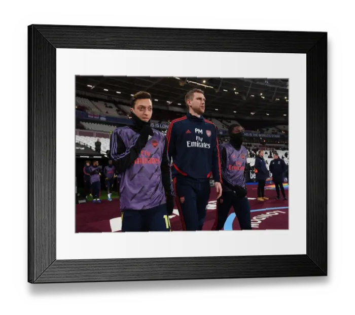Framed Print : Arsenal's Ozil and Mertesacker Lead Team Out Against West Ham in Premier League Clash