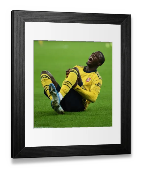 Framed Print : Arsenal's Nicolas Pepe Injured in West Ham Clash: Premier League Showdown, London, 2019 Framed Print : Arsenal's Nicolas Pepe Injured in West Ham Clash: Premier League Showdown, London, 2019