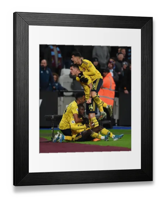 Framed Print : Pepe and Aubameyang Celebrate Arsenal's Winning Goals Against West Ham United (2019-20) Framed Print : Pepe and Aubameyang Celebrate Arsenal's Winning Goals Against West Ham United (2019-20)