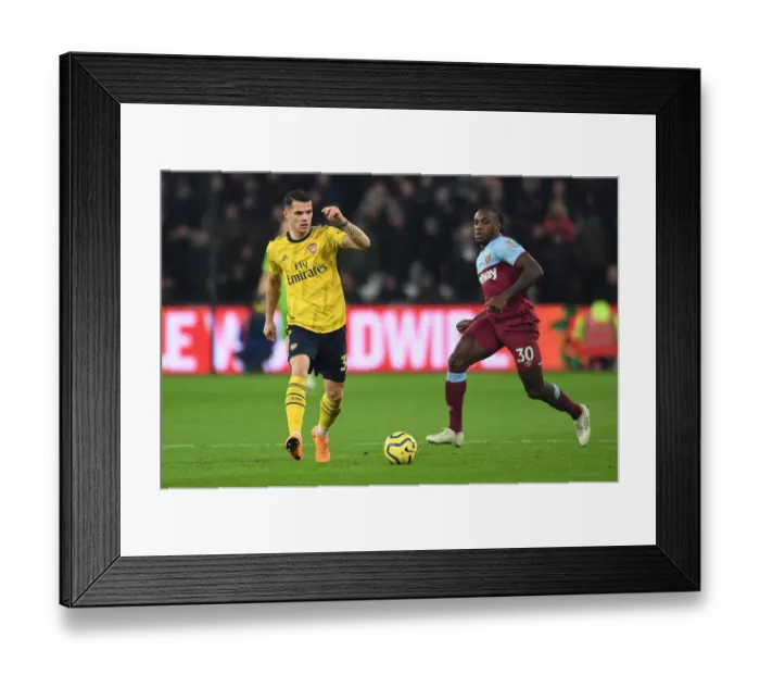 Framed Print : Xhaka vs Antonio: Intense Battle in West Ham United vs Arsenal FC Premier League Clash
