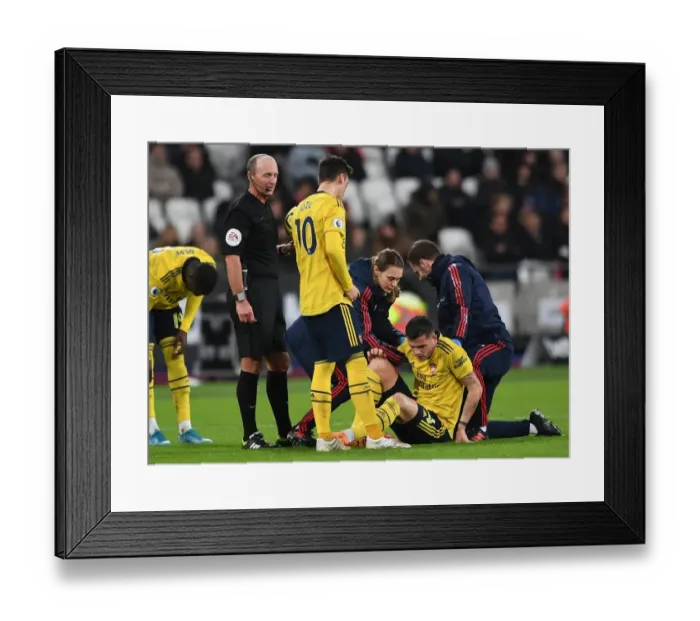 Framed Print : Arsenal's Granit Xhaka Receives Treatment During West Ham Clash (2019-20)