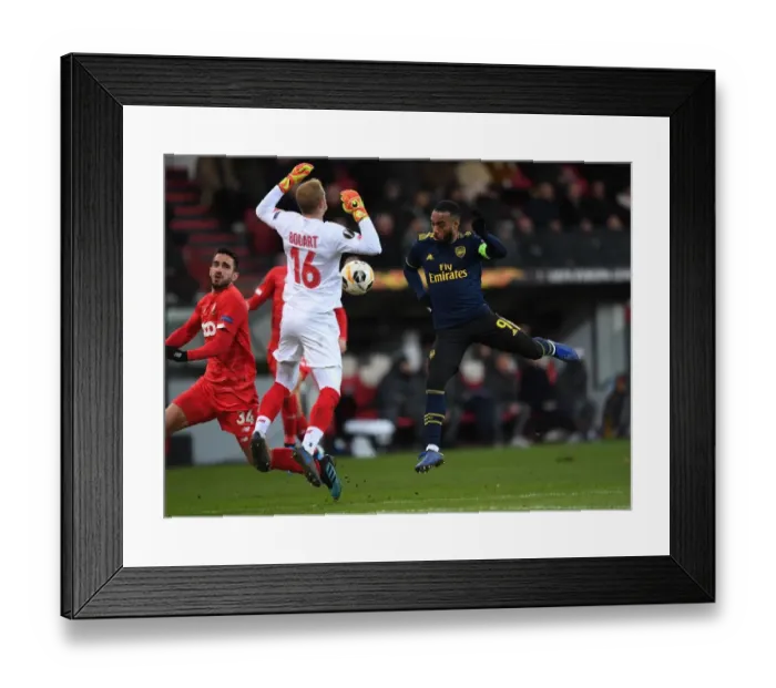 Framed Print : Arsenal's Lacazette Faces Off Against Standard Liege's Bodart in Europa League Clash