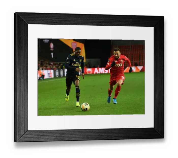 Framed Print : Arsenal's Ainsley Maitland-Niles Faces Off Against Standard Liege's Nicolas Gavory in UEFA Europa League Clash