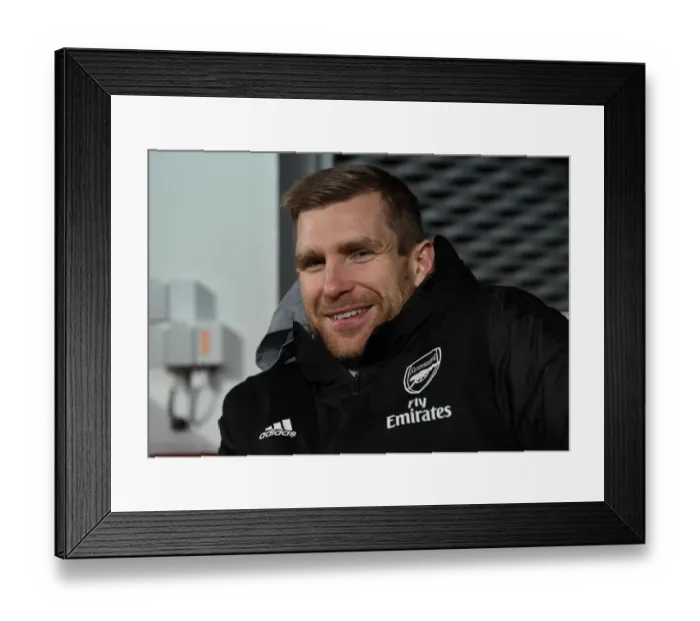 Framed Print : Arsenal's Mertesacker Coaches in UEFA Europa League Match against Standard Liege Framed Print : Arsenal's Mertesacker Coaches in UEFA Europa League Match against Standard Liege