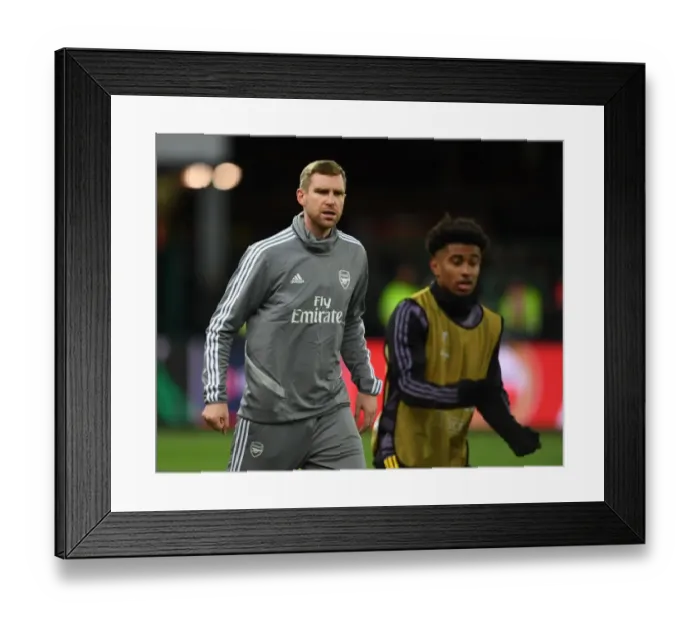 Framed Print : Arsenal's Mertesacker Coaches in UEFA Europa League Match against Standard Liege Framed Print : Arsenal's Mertesacker Coaches in UEFA Europa League Match against Standard Liege