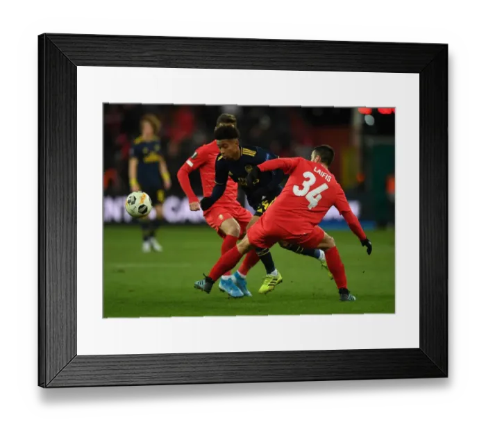 Framed Print : Reiss Nelson Darts Past Kostas Laifis: Arsenal's Europa League Battle at Standard Liege