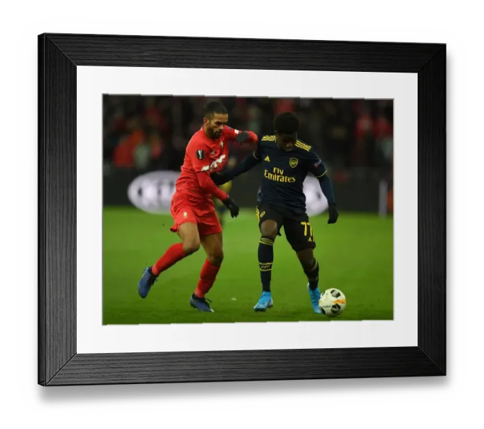 Framed Print : Bukayo Saka vs. Mehdi Carcela: A Europa League Battle at Standard Liege