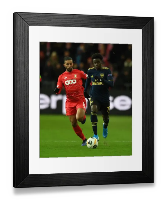 Framed Print : Saka vs. Carcela: A Europa League Battle at Standard Liege Framed Print : Saka vs. Carcela: A Europa League Battle at Standard Liege