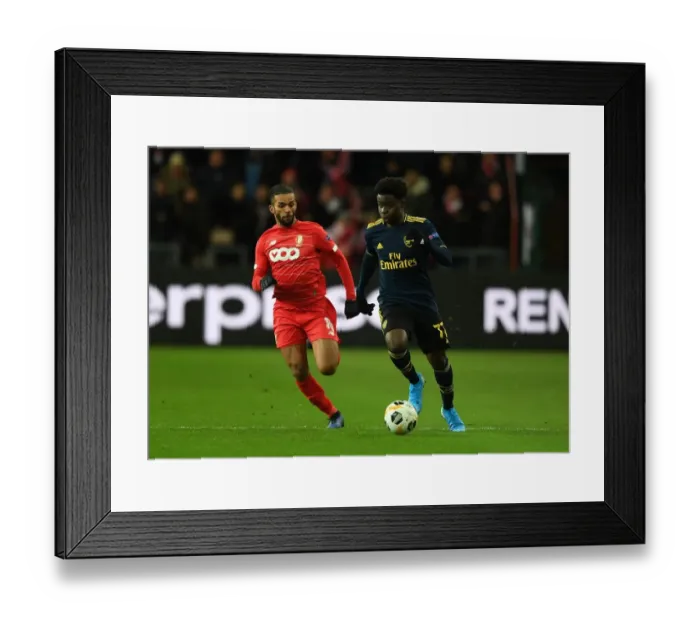 Framed Print : Bukayo Saka vs Mehdi Carcela: A Europa League Battle at Standard Liege Framed Print : Bukayo Saka vs Mehdi Carcela: A Europa League Battle at Standard Liege