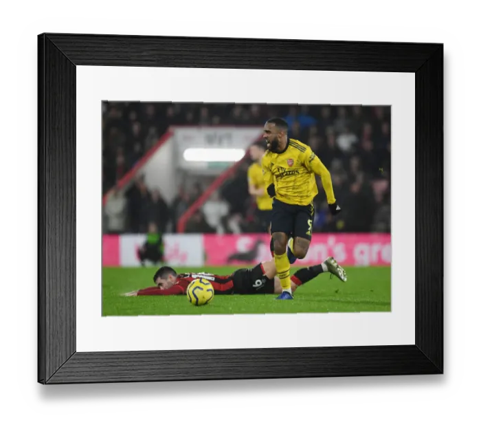 Framed Print : Arsenal's Alex Lacazette Outmaneuvers Bournemouth's Lewis Cook in Premier League Clash (AFC Bournemouth v Arsenal 2019-20)