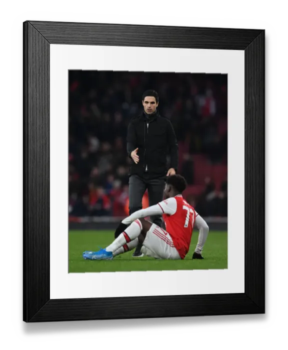 Framed Print : Arsenal's Mikel Arteta Comforts Distressed Bukayo Saka Amidst Chelsea Rivalry