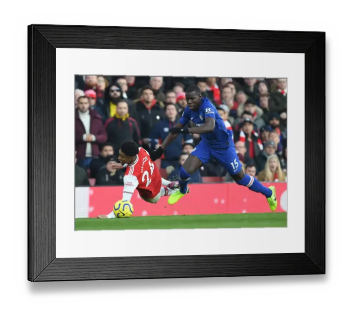 Framed Print : Arsenal vs. Chelsea: Intense Clash at Emirates Stadium - Reiss Nelson vs. Kurt Zouma Framed Print : Arsenal vs. Chelsea: Intense Clash at Emirates Stadium - Reiss Nelson vs. Kurt Zouma